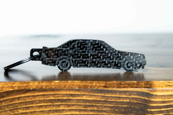 A 190E 2.3 16 valve carbon fiber keychain, front view