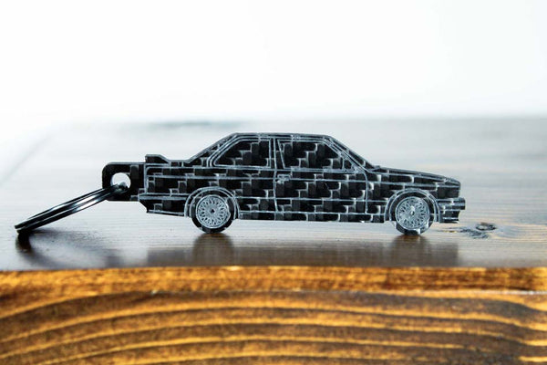 An E30 M3 carbon fiber keychain, front view