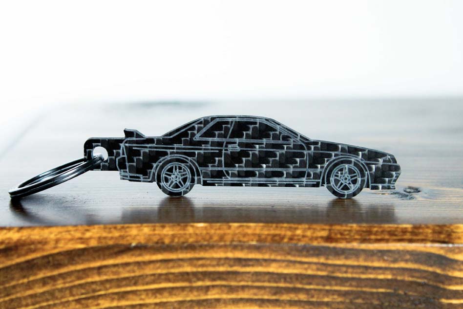 An R32 GTR carbon fiber keychain, front view