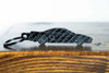 An NSX carbon fiber keychain, front view