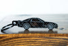 An FD RX-7 carbon fiber keychain, front view