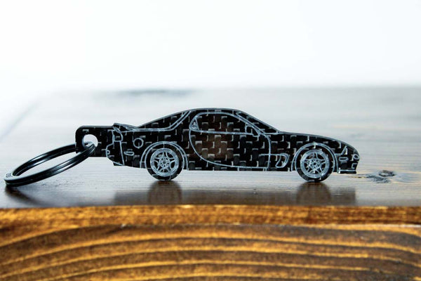 An FD RX-7 carbon fiber keychain, front view