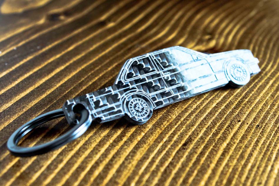 An E30 Coupe carbon fiber keychain, angle view
