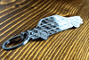An E30 Coupe carbon fiber keychain, angle view