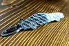 An MK4 Supra carbon fiber keychain, angle view