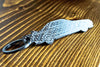 An R32 GTR carbon fiber keychain, angle view