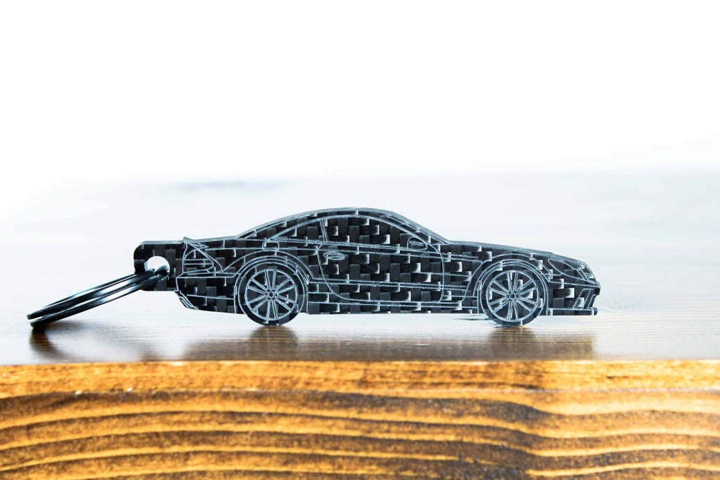 An SL65 Black Series carbon fiber keychain, front view