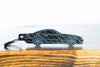 An SL65 Black Series carbon fiber keychain, front view