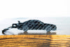 An R34 GTR carbon fiber keychain, front view