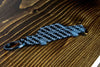 A 242 Turbo Evolution carbon fiber keychain, angle view
