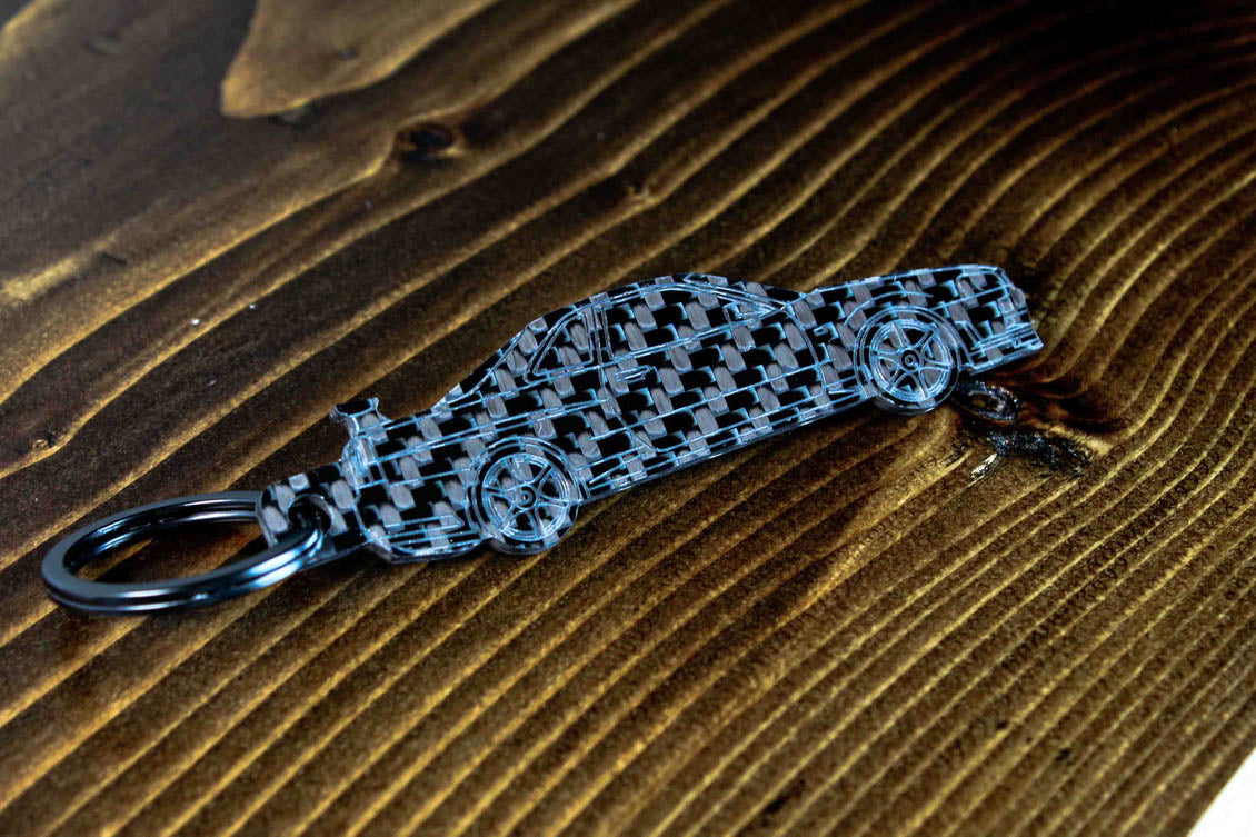 An R34 GTR carbon fiber keychain, angle view
