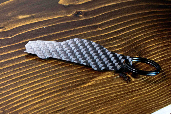 An SL65 Black Series carbon fiber keychain, rear view
