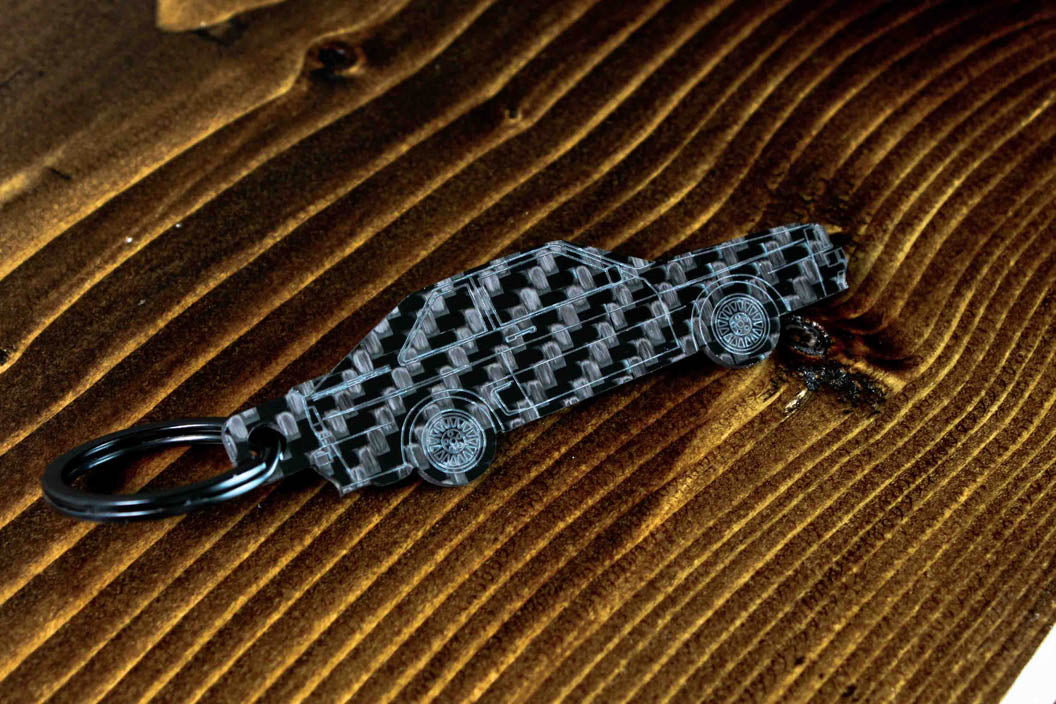 A Sport Quattro carbon fiber keychain, angle view