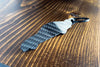 An FD RX-7 carbon fiber keychain, rear view