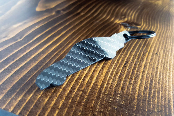 An FD RX-7 carbon fiber keychain, rear view