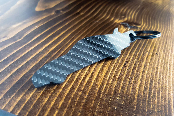 An MK4 Supra carbon fiber keychain, rear view