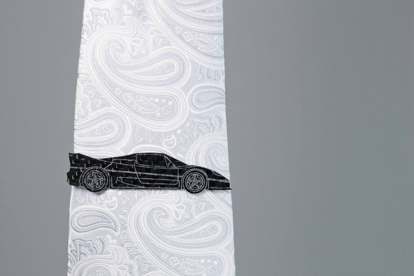 F50 carbon fiber tie clip on a silver tie. Perfect for any car lover. 
