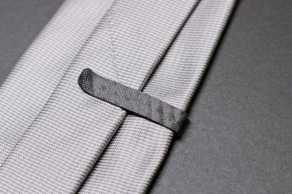 A 959 carbon fiber tie clip, back side on tie