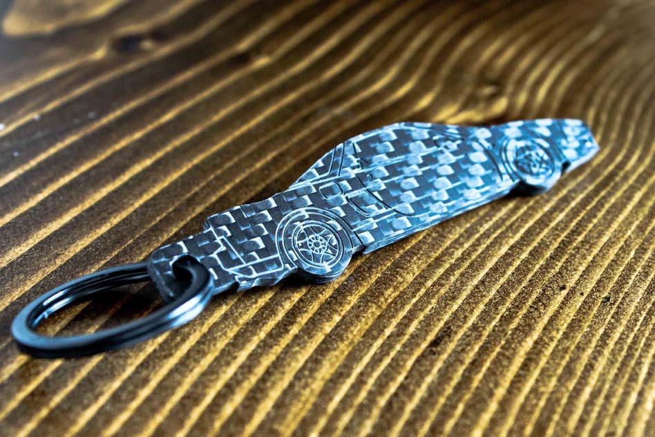 An NSX carbon fiber keychain, angle view