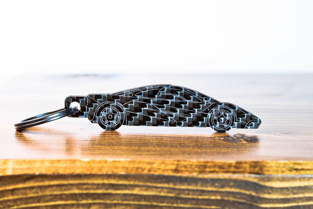 An F1 carbon fiber keychain, front view
