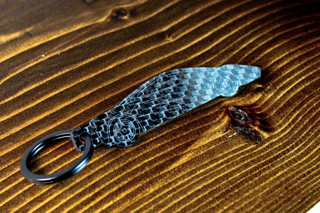 An F1 carbon fiber keychain, angle view